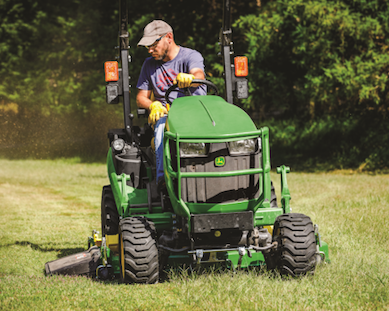 John Deere 1025R Tractor mowing the yard