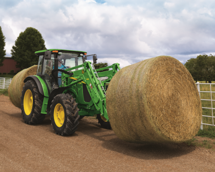 5100M Utility Tractor hauling hay bale