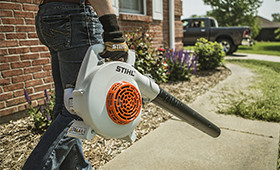 Man using his Stihl Blower to clear his driveway